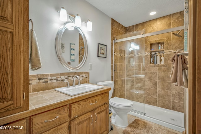 bathroom featuring walk in shower, backsplash, a textured ceiling, toilet, and vanity