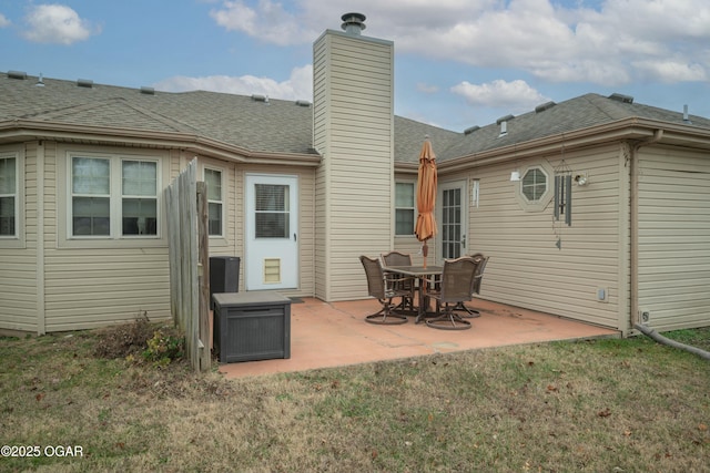 rear view of house featuring a lawn and a patio