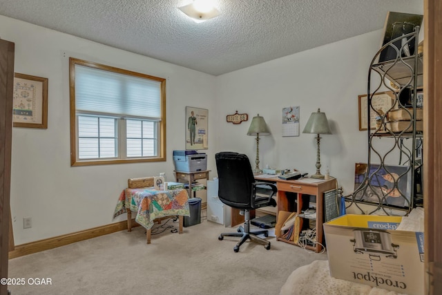 office area featuring light carpet and a textured ceiling