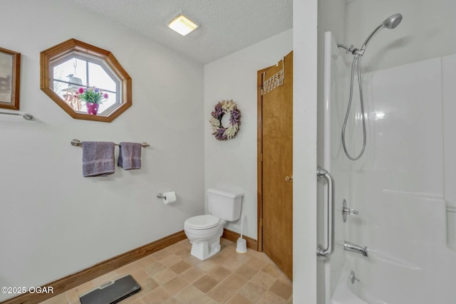 bathroom with a shower, a textured ceiling, and toilet