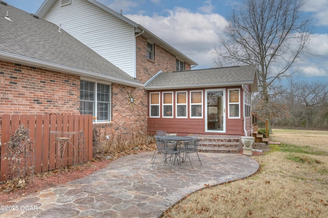 back of property featuring a patio area and a yard