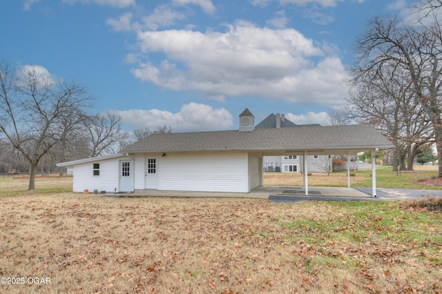 rear view of house featuring a lawn