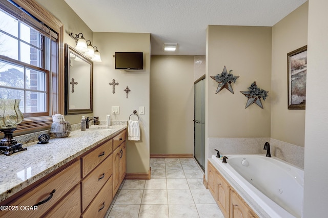 bathroom featuring a textured ceiling, vanity, independent shower and bath, and a healthy amount of sunlight