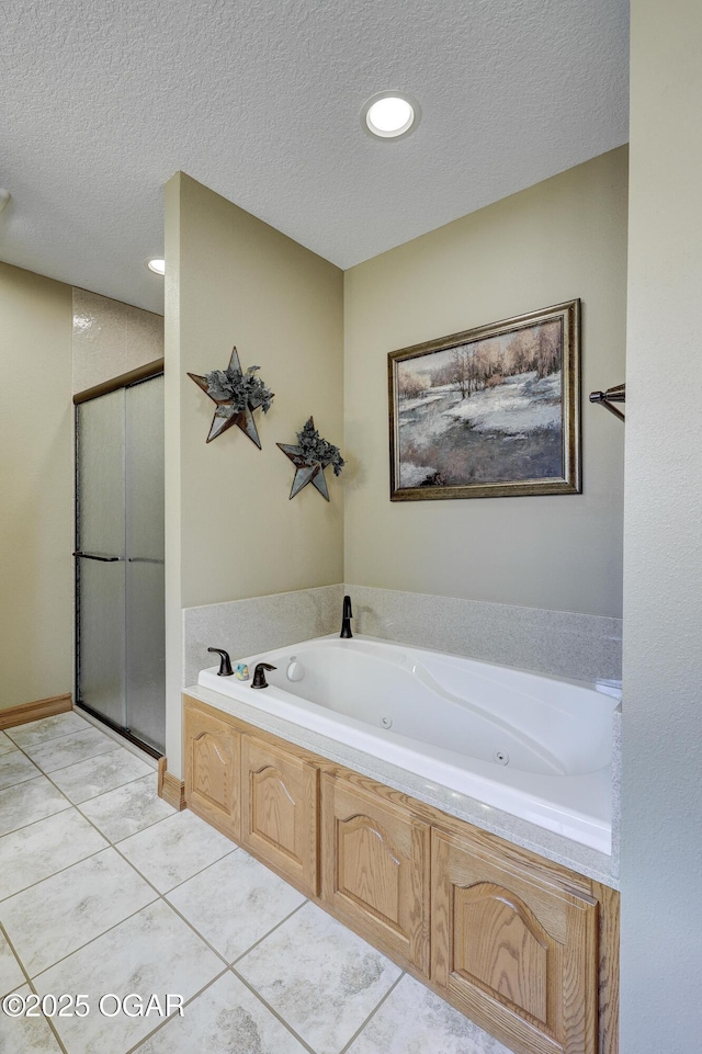 bathroom with separate shower and tub, tile patterned floors, and a textured ceiling