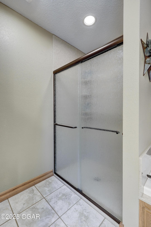 bathroom with tile patterned floors and a shower with shower door