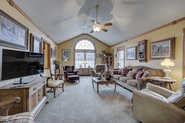 living room featuring lofted ceiling, ceiling fan, carpet floors, and a textured ceiling