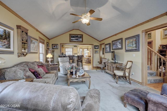 carpeted living room with ceiling fan, lofted ceiling, and ornamental molding