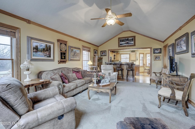 living room with ceiling fan, light colored carpet, lofted ceiling, and ornamental molding