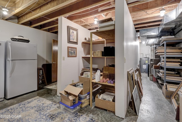 basement featuring white refrigerator and water heater