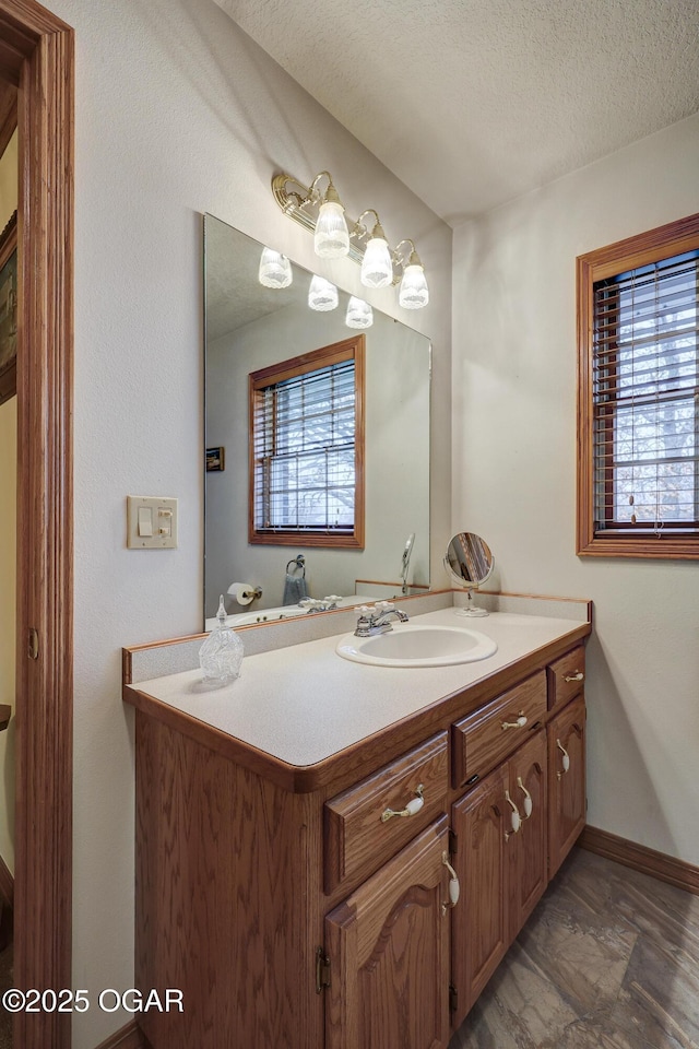 bathroom with a textured ceiling and vanity