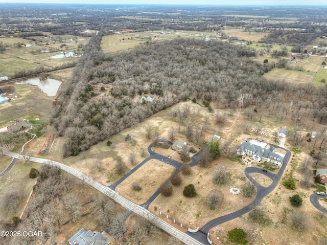 drone / aerial view featuring a water view and a rural view