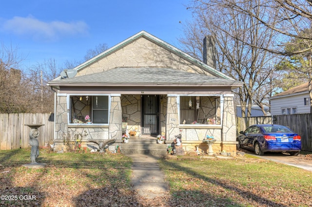 bungalow-style home with a front lawn