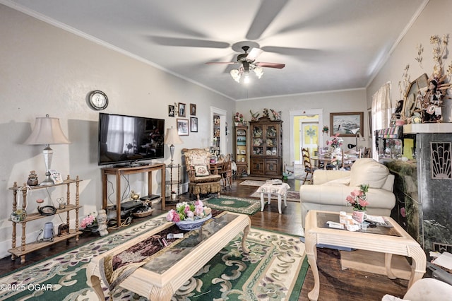 living room with crown molding, hardwood / wood-style floors, and ceiling fan