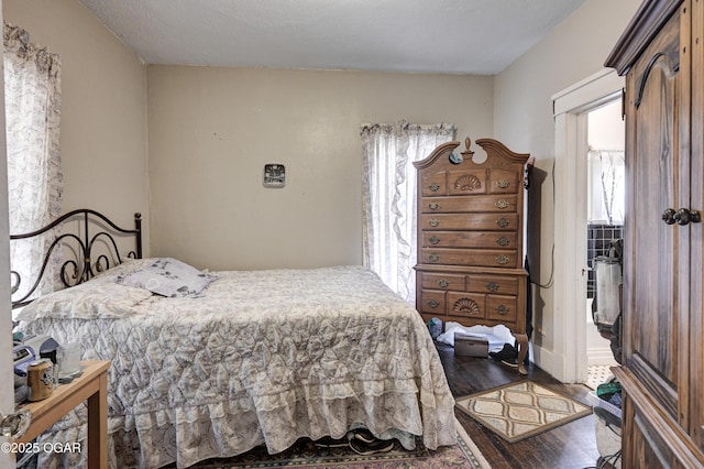 bedroom with wood-type flooring and a textured ceiling