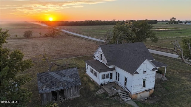 aerial view at dusk featuring a rural view