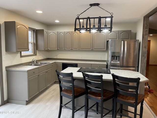 kitchen featuring black appliances, a center island, gray cabinets, and light hardwood / wood-style flooring