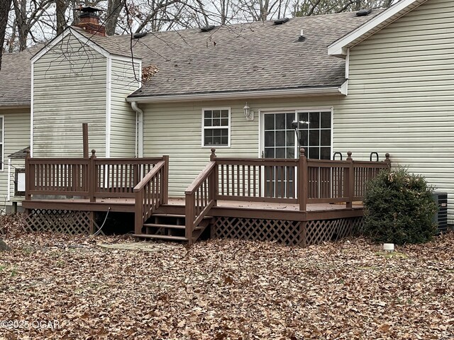 back of property with a wooden deck