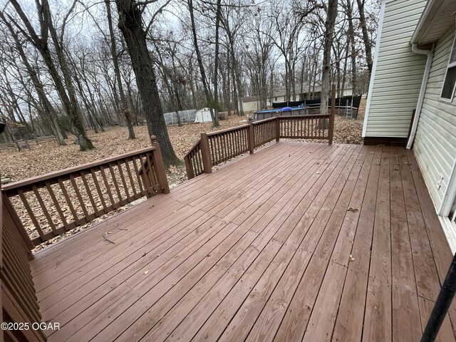 wooden deck with a trampoline