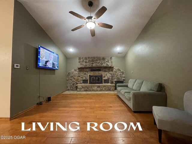 living room featuring hardwood / wood-style floors, ceiling fan, and lofted ceiling