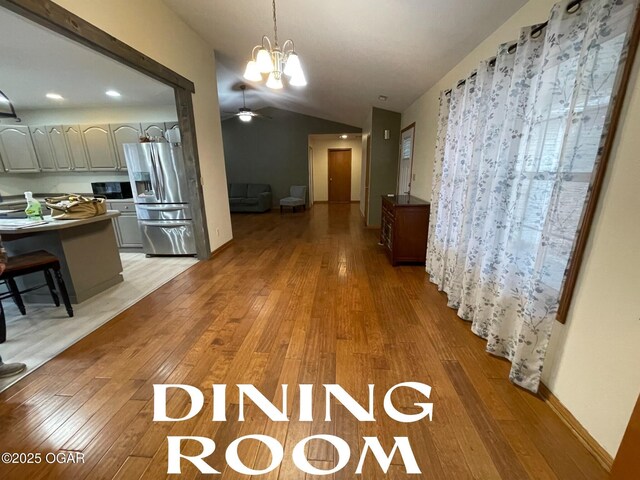 interior space with hardwood / wood-style flooring, lofted ceiling, and a chandelier