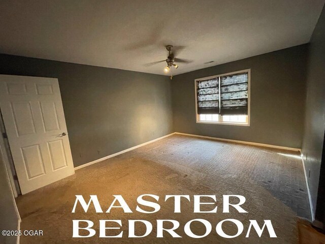 carpeted empty room with ceiling fan