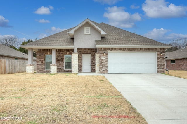 view of front of house with a garage and a front lawn