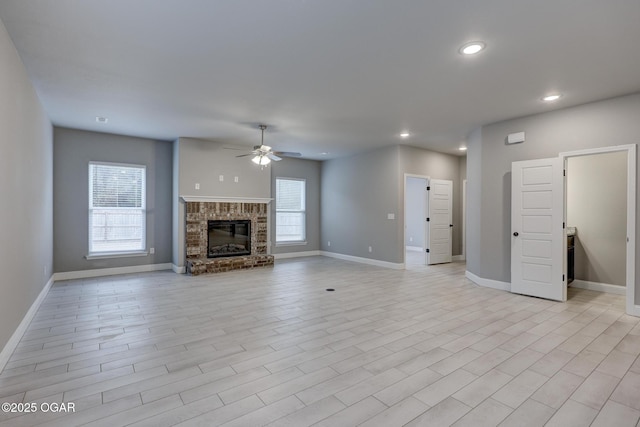 unfurnished living room with ceiling fan