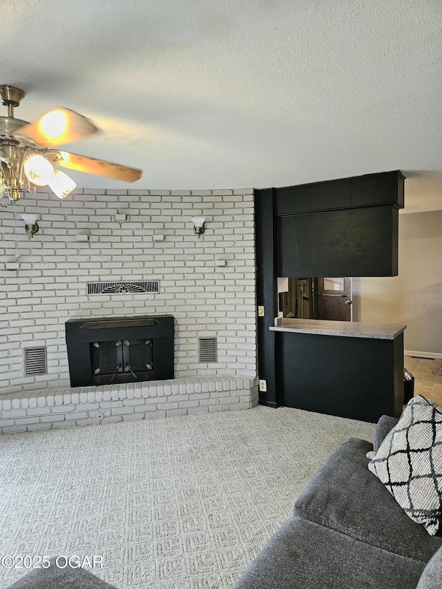 living room featuring a textured ceiling and ceiling fan