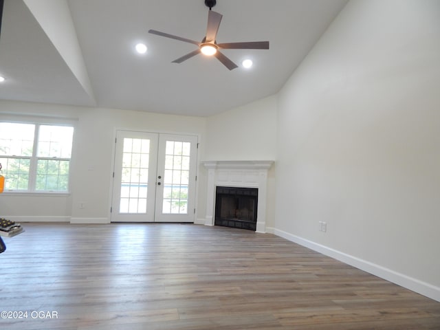 unfurnished living room with hardwood / wood-style flooring, ceiling fan, a healthy amount of sunlight, and french doors