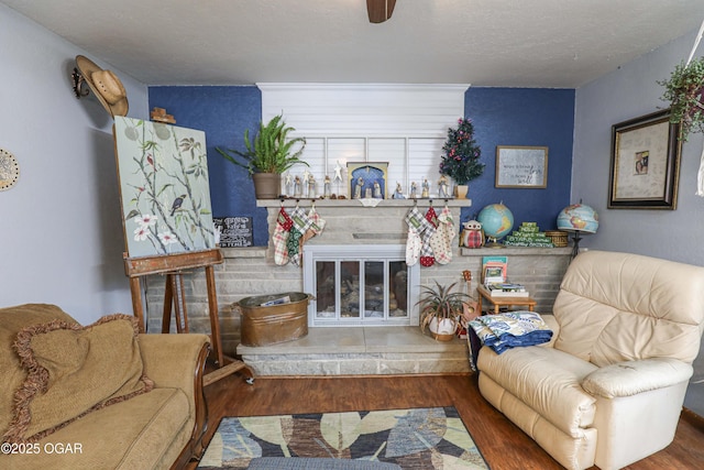 202 Arbor Dr, Lamar, MO 64759 - living room with a textured ceiling, a large fireplace, and dark wood-type flooring