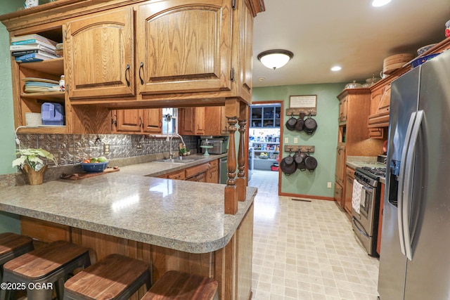 202 Arbor Dr, Lamar, MO 64759 - kitchen with kitchen peninsula, sink, appliances with stainless steel finishes, and a breakfast bar area