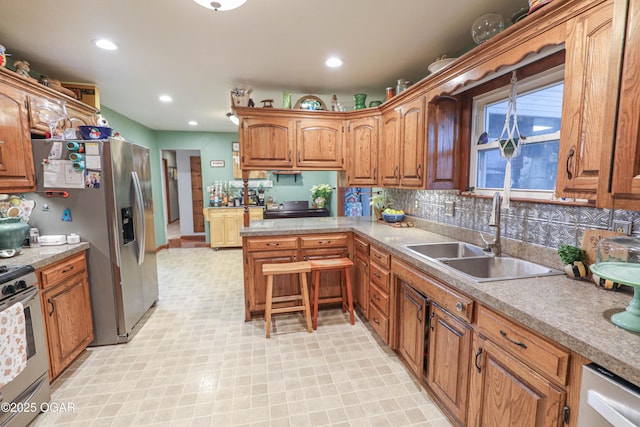 202 Arbor Dr, Lamar, MO 64759 - kitchen with sink, appliances with stainless steel finishes, and tasteful backsplash