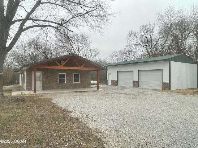 view of front of home featuring a garage and an outdoor structure