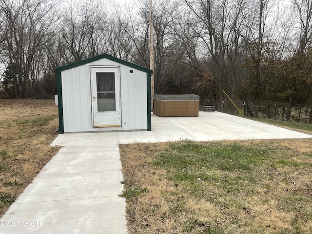 view of outdoor structure featuring a lawn and a hot tub