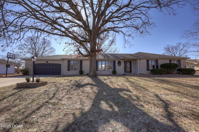 ranch-style home featuring a garage and a front yard