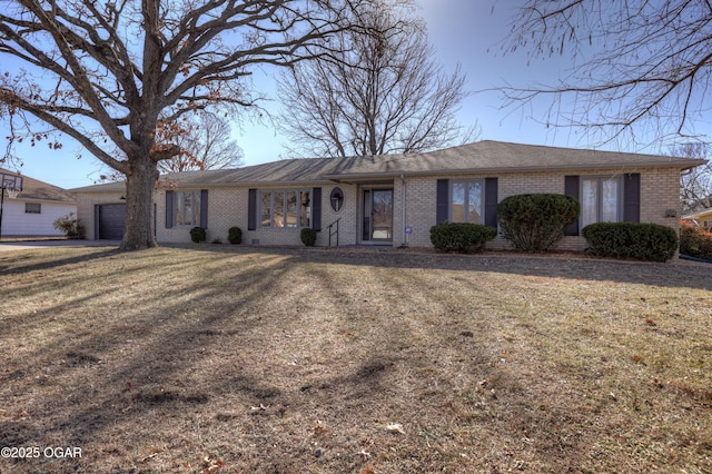 single story home featuring a garage and a front lawn