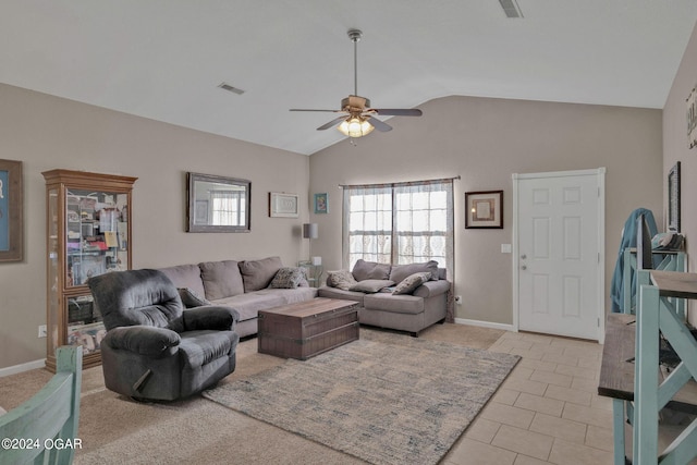 living room featuring ceiling fan, light tile patterned floors, and vaulted ceiling