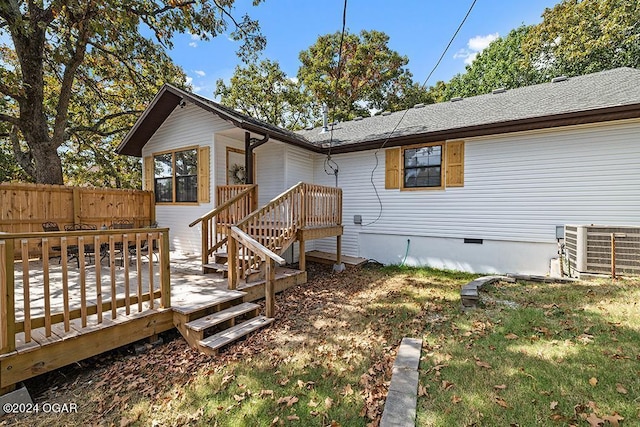 back of property featuring a yard, cooling unit, and a wooden deck