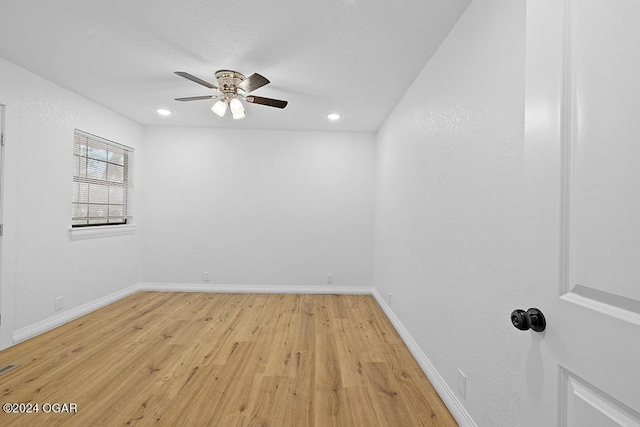 spare room featuring light hardwood / wood-style floors and ceiling fan