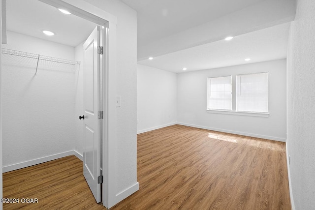 interior space with wood-type flooring and a closet