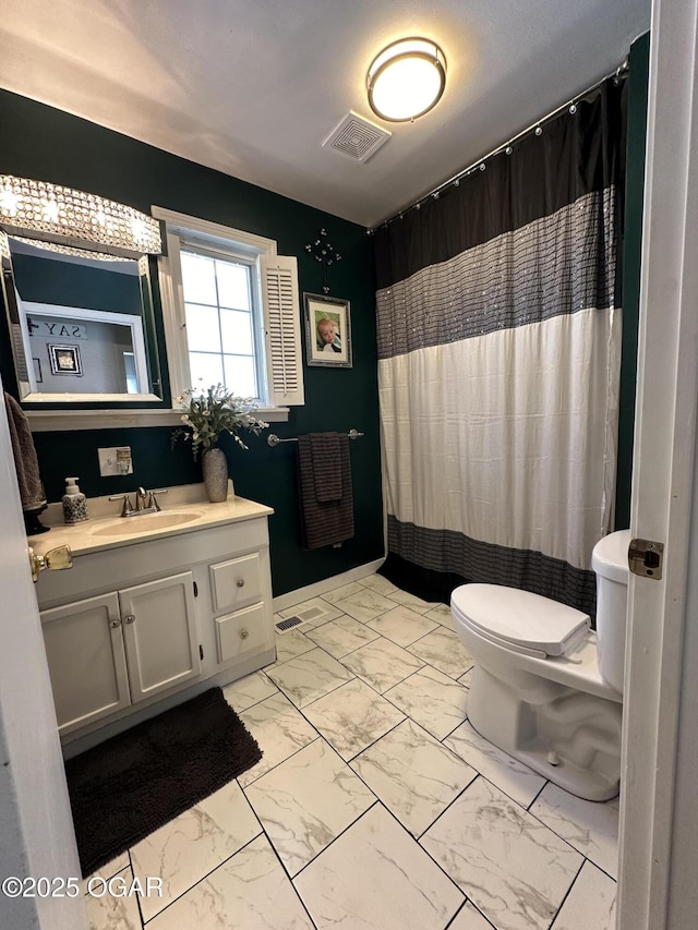 bathroom featuring vanity, curtained shower, and toilet