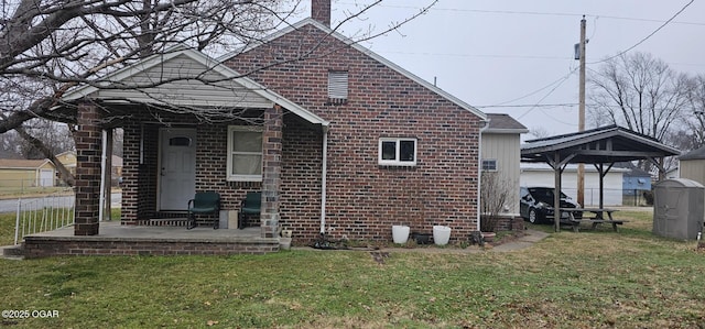 view of side of home with a gazebo and a yard