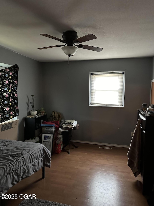 bedroom featuring ceiling fan and wood-type flooring