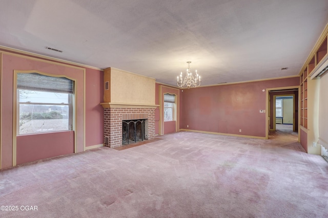 unfurnished living room featuring light colored carpet, ornamental molding, a fireplace, and a chandelier