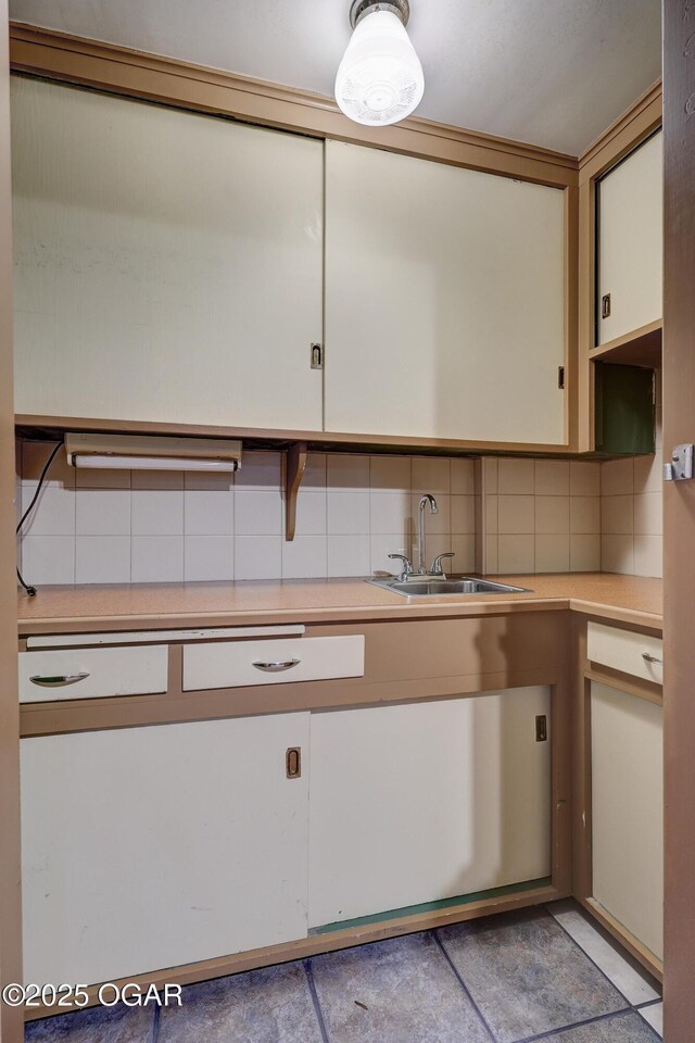 kitchen featuring tasteful backsplash and sink