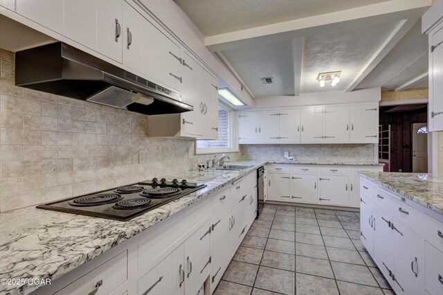 kitchen with white cabinetry, sink, tasteful backsplash, light tile patterned floors, and black appliances