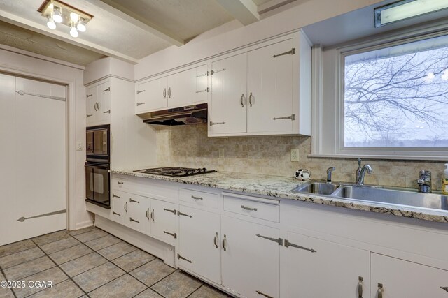 kitchen featuring decorative backsplash, sink, black appliances, white cabinets, and light tile patterned flooring