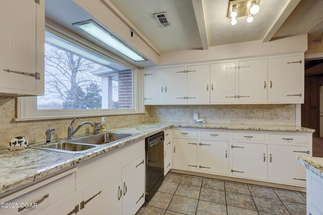 kitchen featuring black dishwasher, backsplash, white cabinetry, and sink