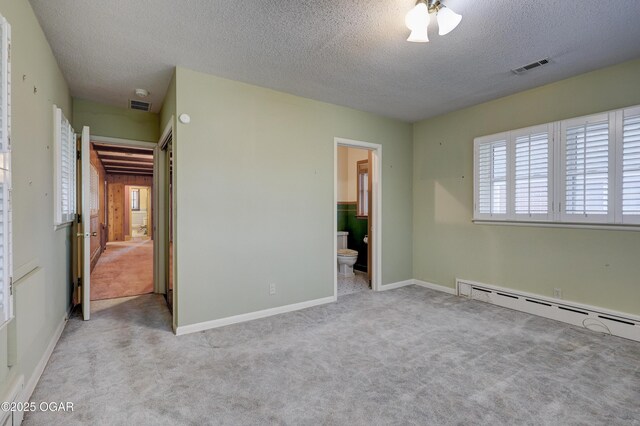 unfurnished bedroom with connected bathroom, ceiling fan, a baseboard radiator, light colored carpet, and a textured ceiling