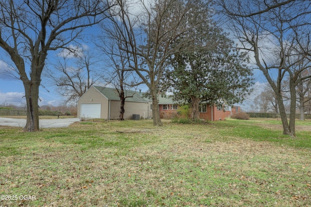 view of yard featuring cooling unit and a garage